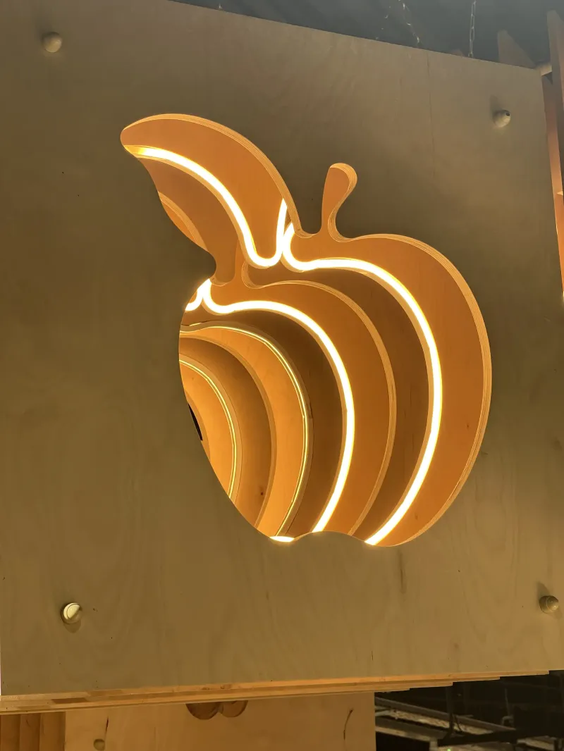 Detail of illuminated timber layers forming an apple shape