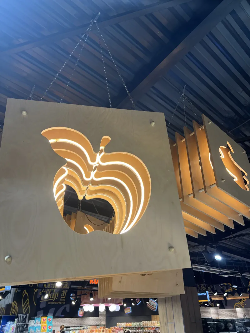 Layered backlit apple-shaped panels inside the shop